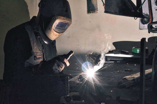 Person welding for manufacture
